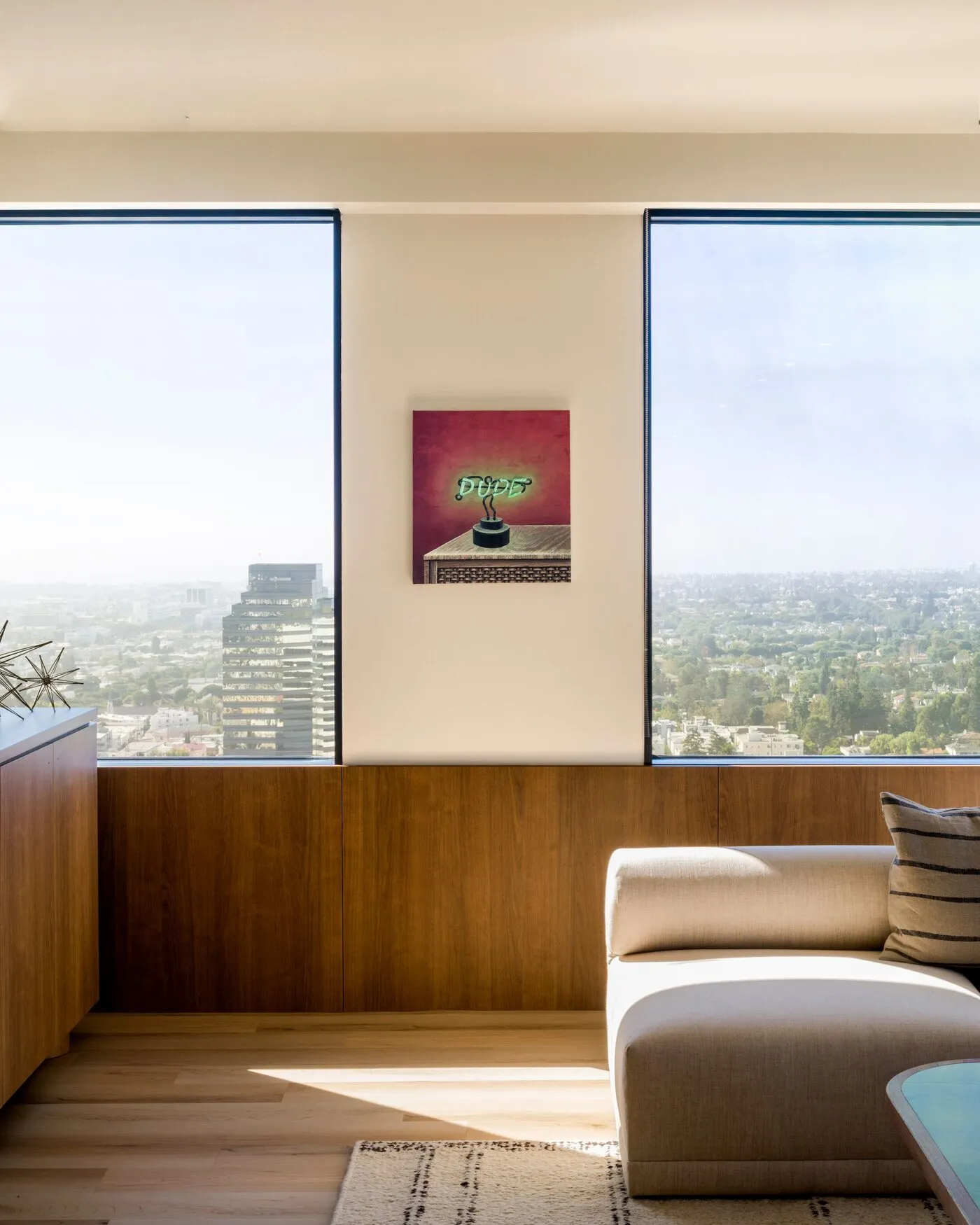 Interior with curated artwork and city view