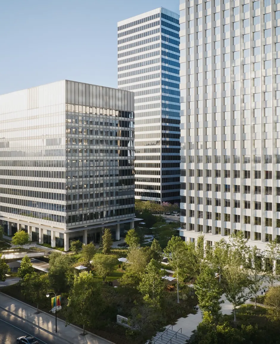Exterior of the Anderson Towers office buildings rising above a tree filled landscaped plaza