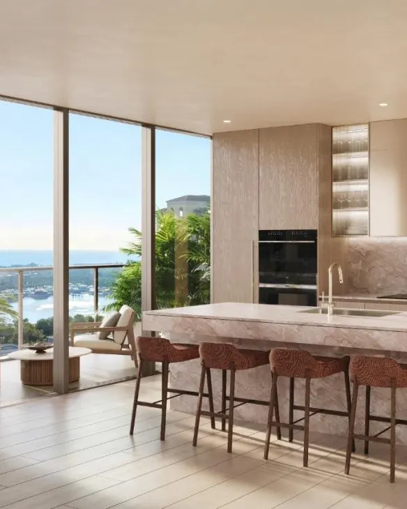 Kitchen rendering with a pale marble island, woven bar stools and floor-to-ceiling windows overlooking the water