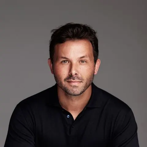 Portrait of Brian Ludlow, founder of Creative Art Partners, in a black polo shirt
