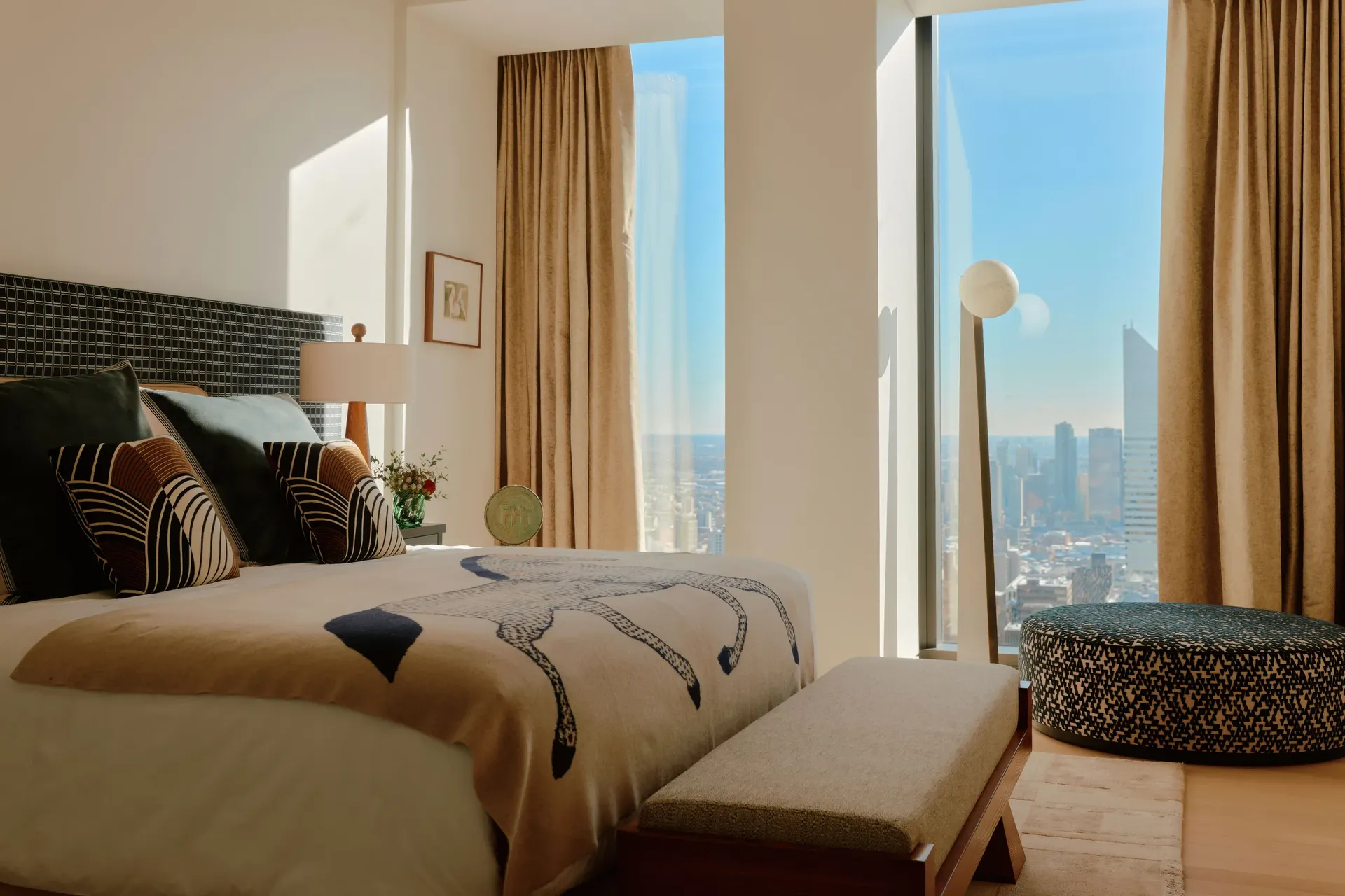 Bedroom in the Residence 69 model apartment at 53 West 53, with Midtown Manhattan skyline views
