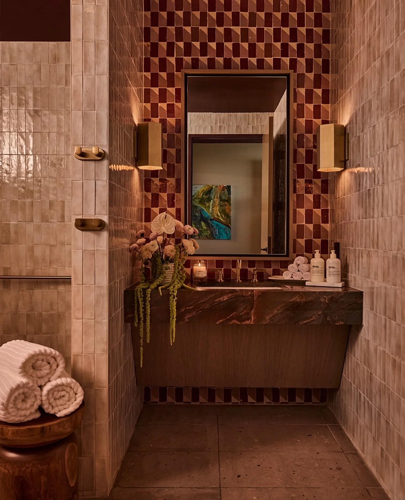 PS DFW powder room with glazed tile walls, a red marble vanity and a colorful artwork reflected in the mirror